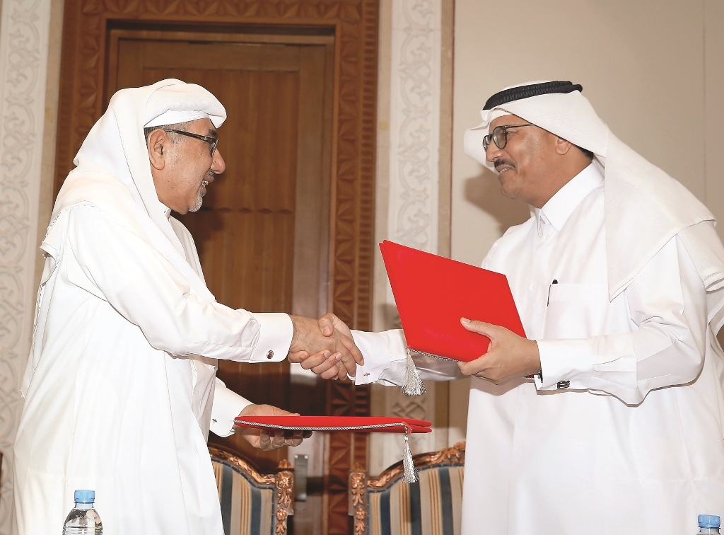 Issa Mohamed Al Ishaq (left), Deputy Communication Manager, Qatar Red Crescent Society, and Dr Saad Al Kaabi, Head of GIT Department, HMC, exchanging documents after signing an agreement for Hepatitis C treatment at a Symposium on Hepatitis C held at the 