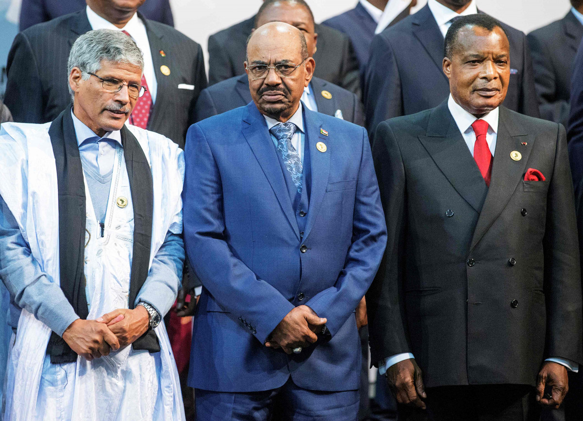 This file photo taken on June 14, 2015 shows Sudanese President Omar al-Bashir (C) standing next to Congo's president Denis Sasso-Nguesso (R) and Prime Minister of the Sahrawi Arab Democratic Republic Abdelkader Taleb Oumar (L) posing during a photo call 