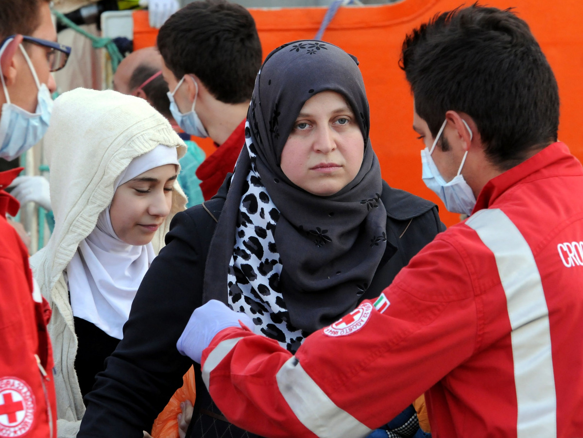 Women disembark from the Siem Pilot on October 24, 2016 in Palermo after rescue operations of migrants at see during the week-end. During a dramatic 24 hours, the crew of the Norwegian Siem Pilot, a vessel built as an oil platform supply ship but now used