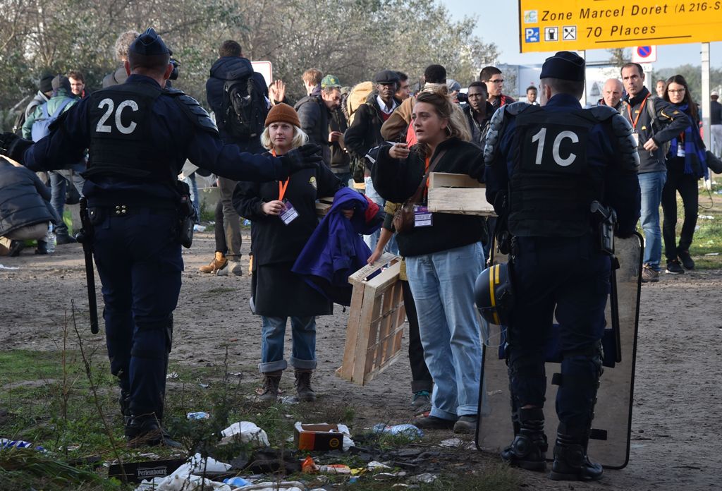 French policemen talk to volunteers in the 