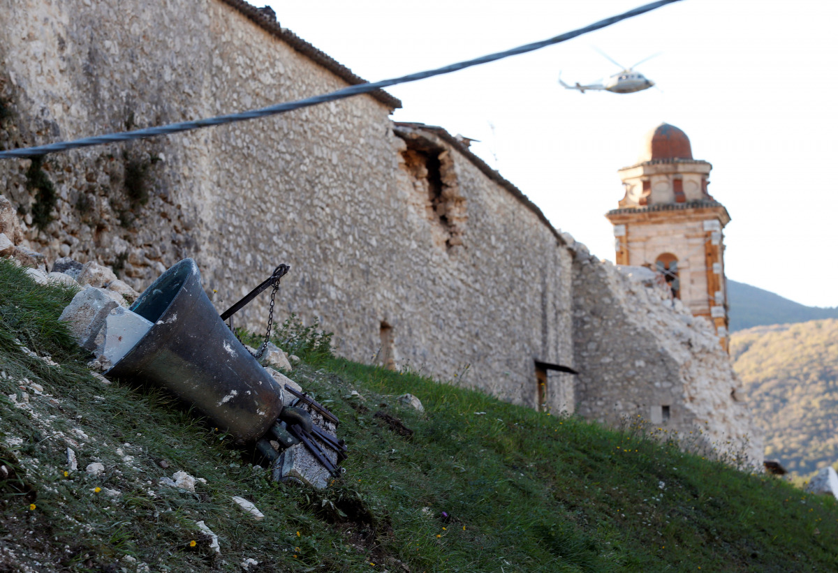 A bell is seen on the ground near a church following an earthquake in Norcia, Italy, October 30, 2016. (REUTERS/Remo Casilli)