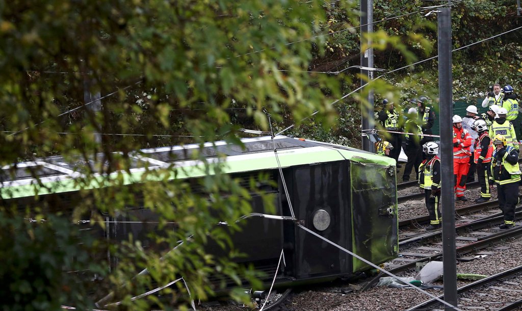 Members of the emergency services work next to a tram after it overturned injuring and trapping some passengers in Croydon, south London, Britain November 9, 2016. REUTERS/Neil Hall 
