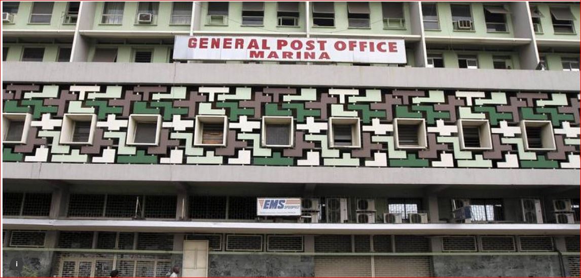 People walk past the general post office in the central business district in Lagos January in this 2012 file photo. REUTERS/Akintunde Akinleye