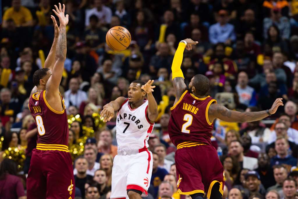 Kyle Lowry #7 of the Toronto Raptors passes between Channing Frye #8 and Kyrie Irving #2 of the Cleveland Cavaliers during the second half at Quicken Loans Arena on November 15, 2016 in Cleveland, Ohio. Jason Miller/Getty Images/AFP