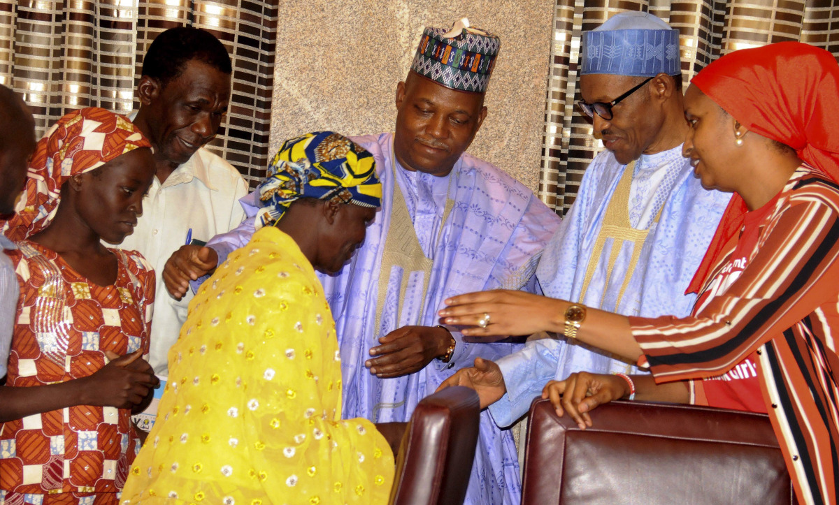 File photo of Nigerian president Muhammadu Buhari meeting with the rescued girl Amina Ali Nkeki and her mother Binta Ali Nkeki with Governor Kashim Shettima of Borno State at the Presidential villa in Abuja, May 2016.  (EPA) 