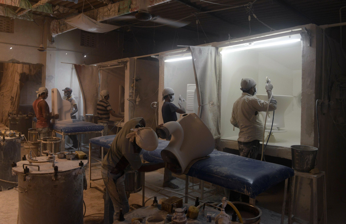 Indian skilled workers build toilets at a factory in Morbi, some 230km from Ahmedabad, on November 18, 2016, on the eve of World Toilet Day. World Toilet Day (WTD), held on November 19 each year, is a campaign held around the world to mobilize people over