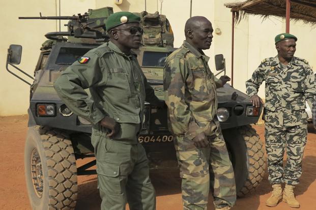 Malian military soldiers stand near an armoured vehicle that belongs to the French Army at the Malian military Command Post in Sevare.Photo: Reuters