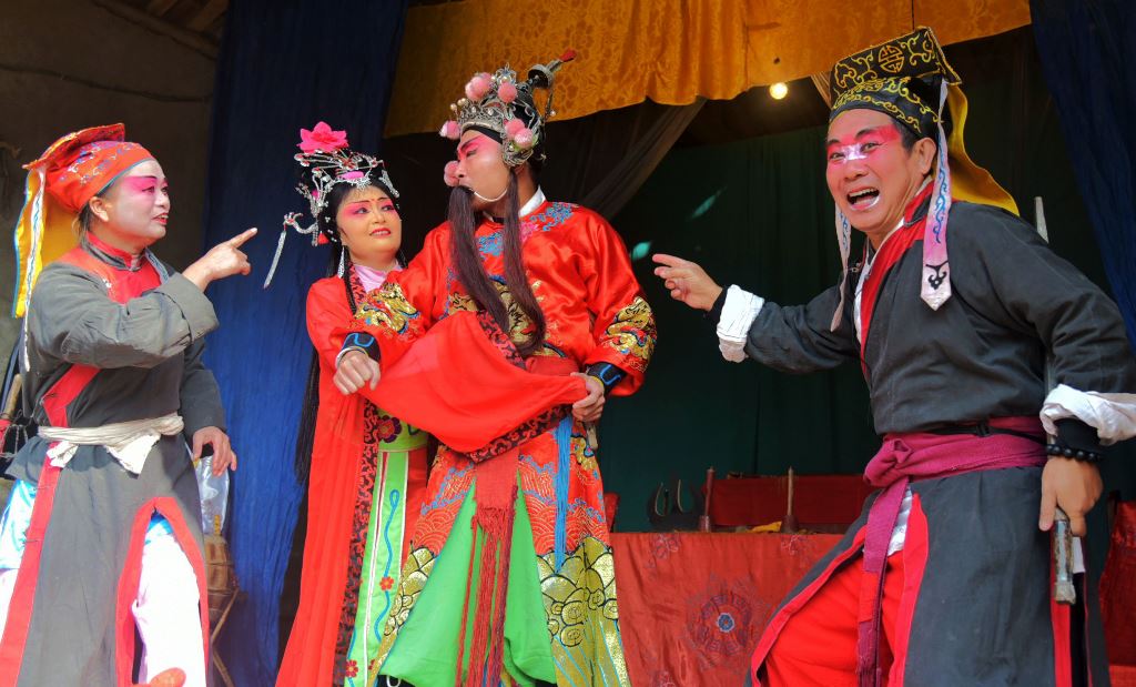 This photo taken on November 19, 2016 shows actors from the Jinyuan Opera Company performing in a temple in White Horse town in Daying, in China's southwest Sichuan province. AFP / STR 