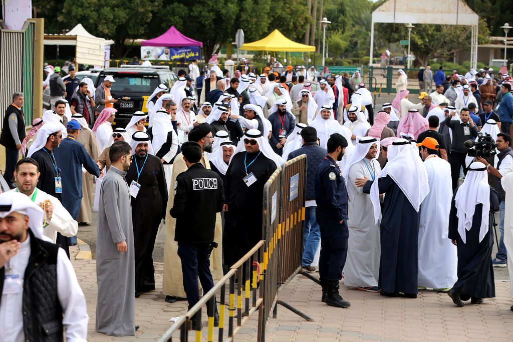 Kuwaiti men arrive to cast their votes for the parliamentary elections at a polling station in Kuwait City on November 26, 2016. Polls opened in Kuwait for the oil-rich Gulf state's seventh general election in a decade, at a time of sharp disputes over su