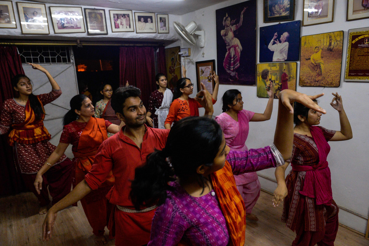 A twenty-six year old Kishan Manocha (3rd L) participates in an Odissi dance lesson under the tutelage of acclaimed dancer Madhumita Raut inside a garage-turned-studio in New Delhi. Class participants range from from pre-teens to surgeons and marketing ma