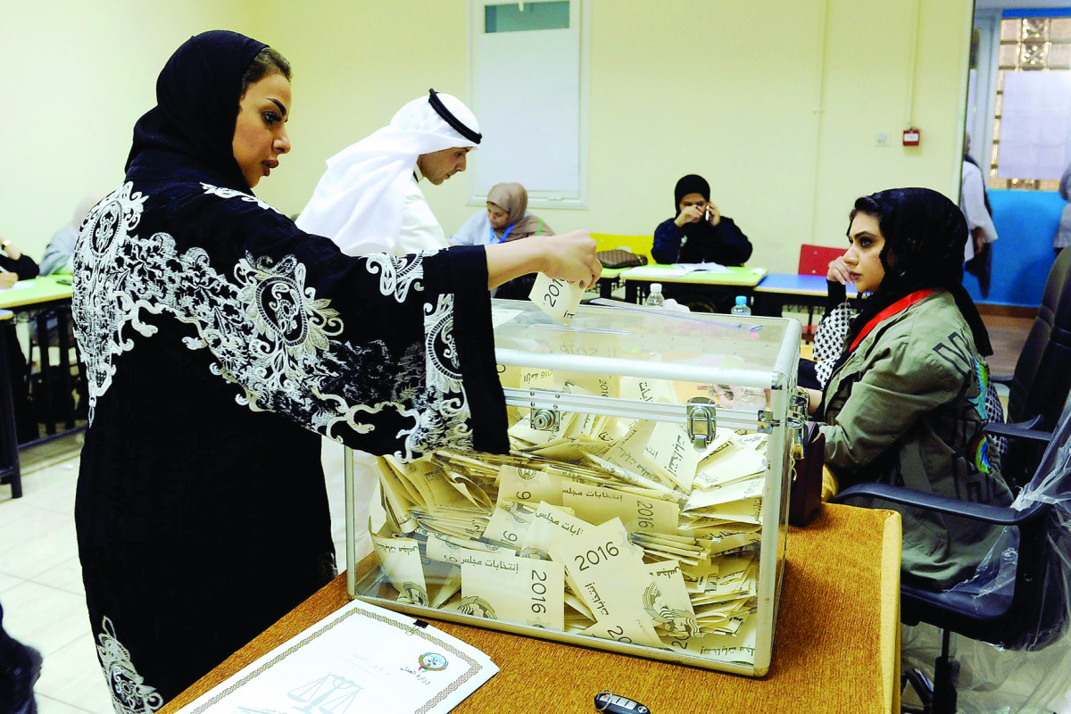 A Kuwaiti woman casts her vote.