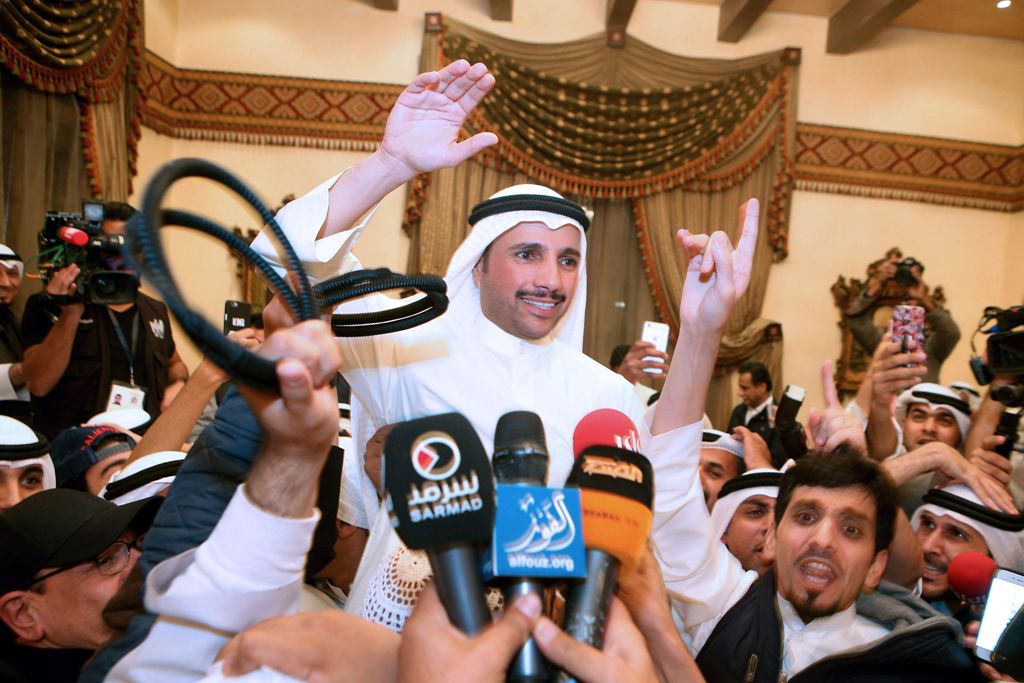 Kuwaiti candidate and former parliament speaker Marzouq al-Ghanem (C), celebrates with his supporters following the announcment of his victory in the parliamentary election, in Kuwait city, early November 27, 2016.  AFP / Yasser Al-Zayyat
