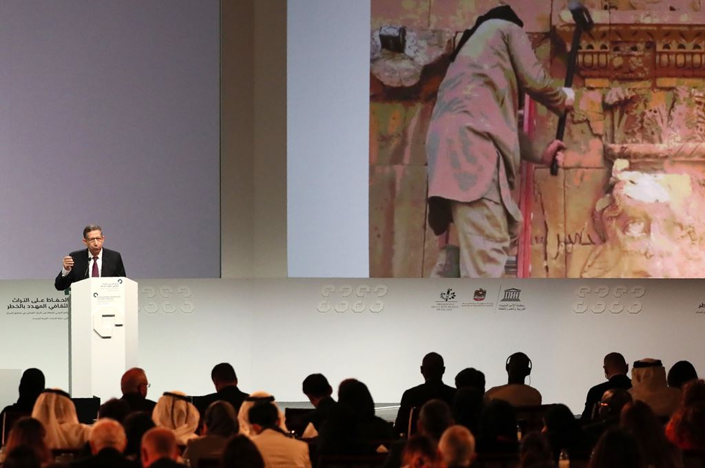 Director of the Arab Regional Centre for World Heritage, Mounir Bouchenaki speaks in front of a giant screen during the opening ceremony of a conference gathering officials and experts from around the world gather to discuss forming a global alliance to p