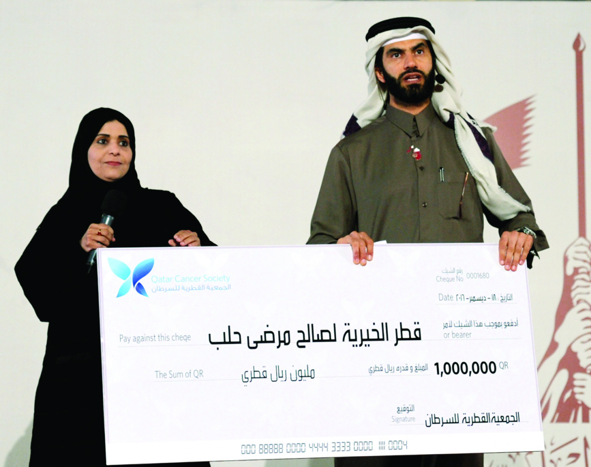 Officials holding a cheque of one million, donated by Qatar Cancer Society, during the fund-raising campaign to support Syrians in the besieged city of Aleppo, at Darb El Saai, yesterday. Pic: Salim Matramkot/The Peninsula