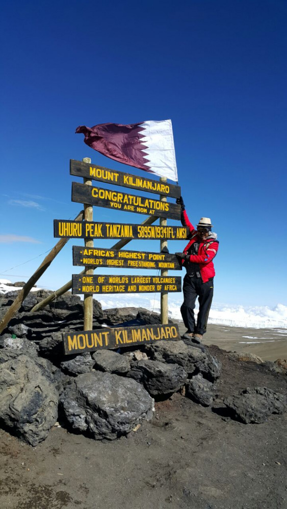 Rajesh Mandge with the Qatari flag on Mount Kilimanjaro in Tanzania.