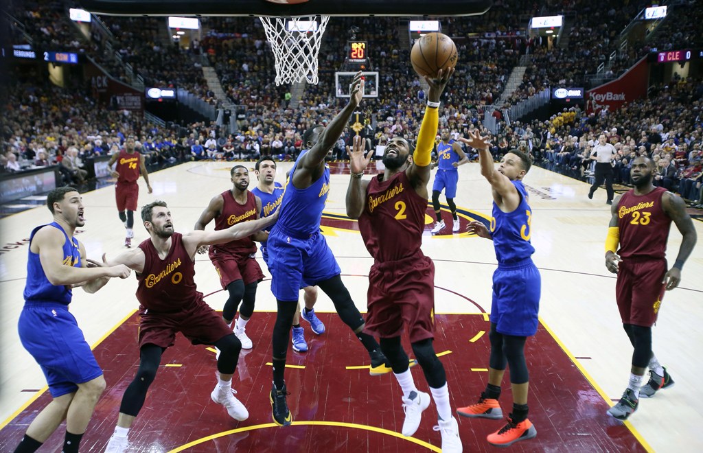 Cleveland Cavaliers guard Kyrie Irving (2) takes a shot against Golden State Warriors forward Draymond Green (23) at Quicken Loans Arena. Cleveland defeats Golden State 109-108.  Brian Spurlock