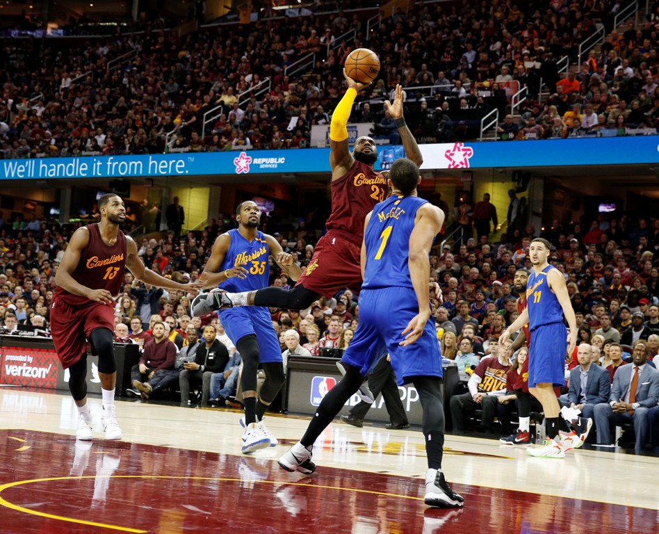 Cleveland Cavaliers forward LeBron James (23) takes a shot against Golden State Warriors center JaVale McGee (1) at Quicken Loans Arena. Cleveland defeats Golden State 109-108. Brian Spurlock