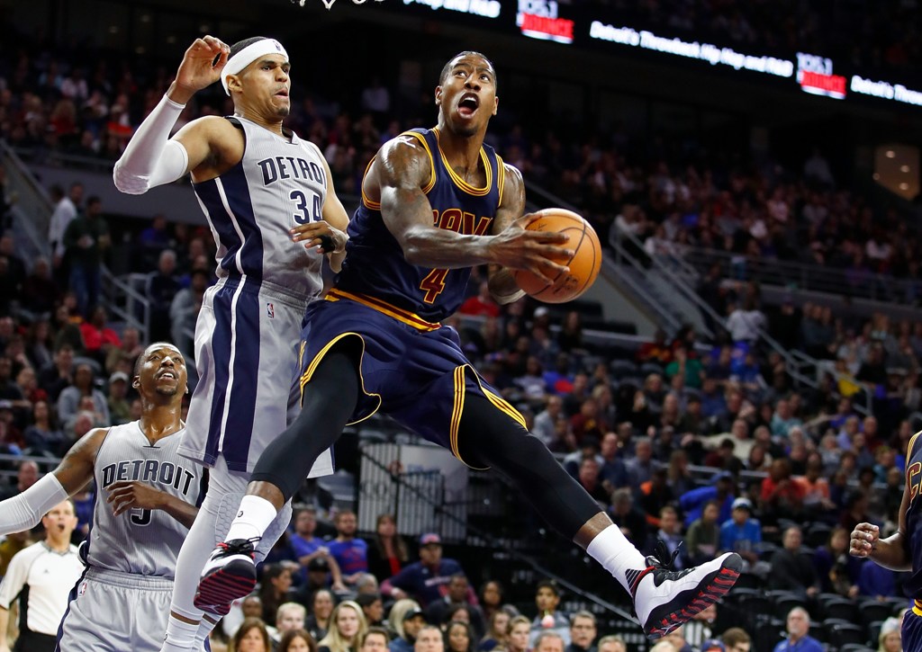 Iman Shumpert #4 of the Cleveland Cavaliers looks to get a shot off around Tobias Harris #34 of the Detroit Pistons during the second half at the Palace of Auburn Hills on December 26, 2016 in Auburn Hills, Michigan. Gregory Shamus/AFP
