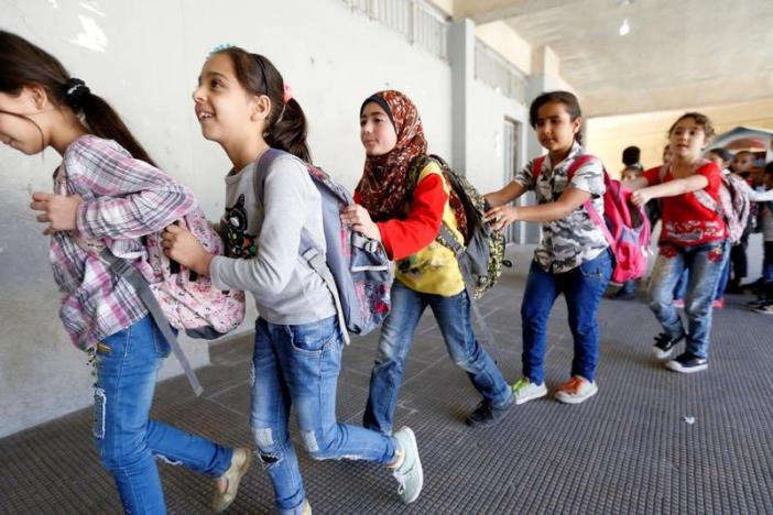 Syrian refugee children queue as they head towards their classroom at a school in Mount Lebanon, October 7, 2016. REUTERS/Mohamed Azakir