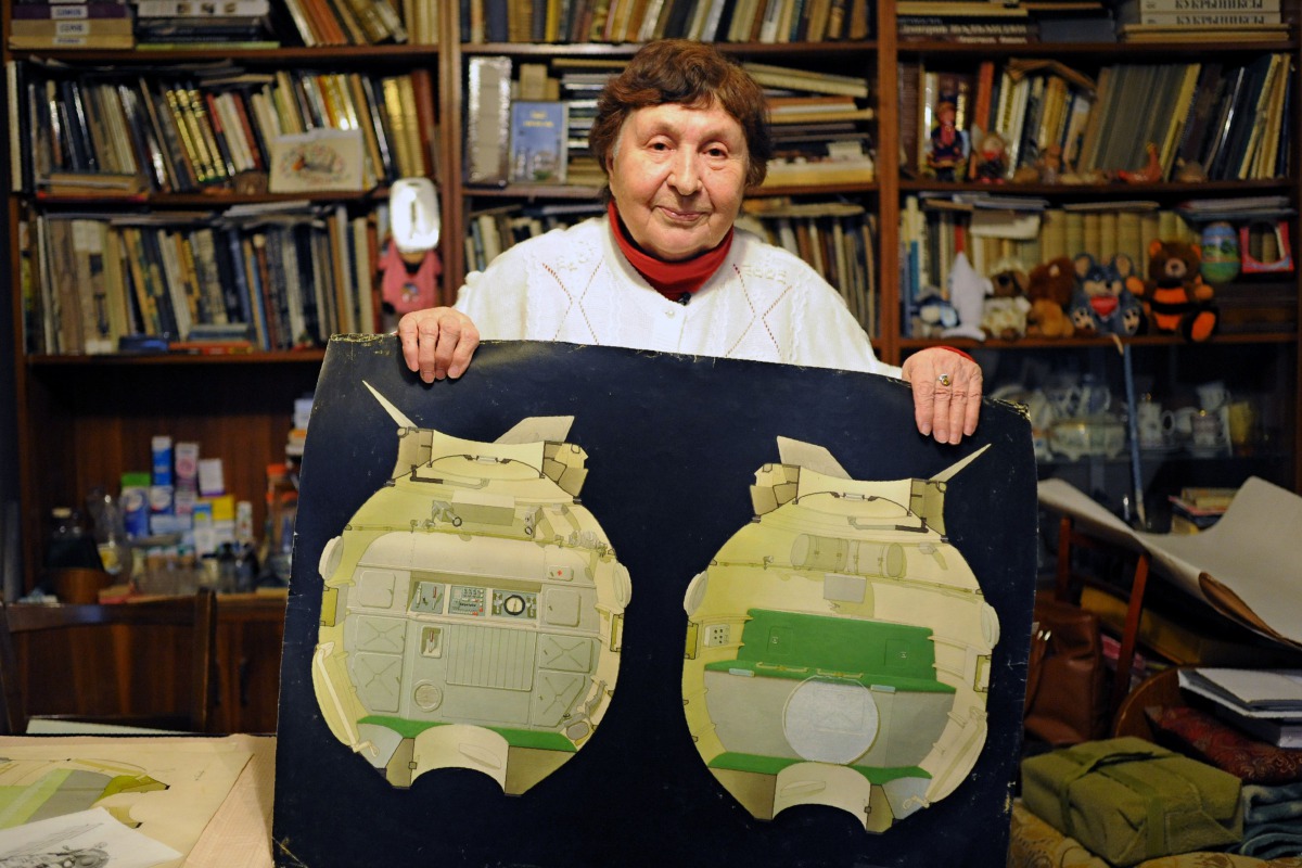 Galina Balashova, the artist who designed the first space habitation module for Soviet cosmonauts, shows drawings of her work in the city of Korolyov outside Moscow on October 21, 2016. An architect by training and an artist at heart, Balashova went on to