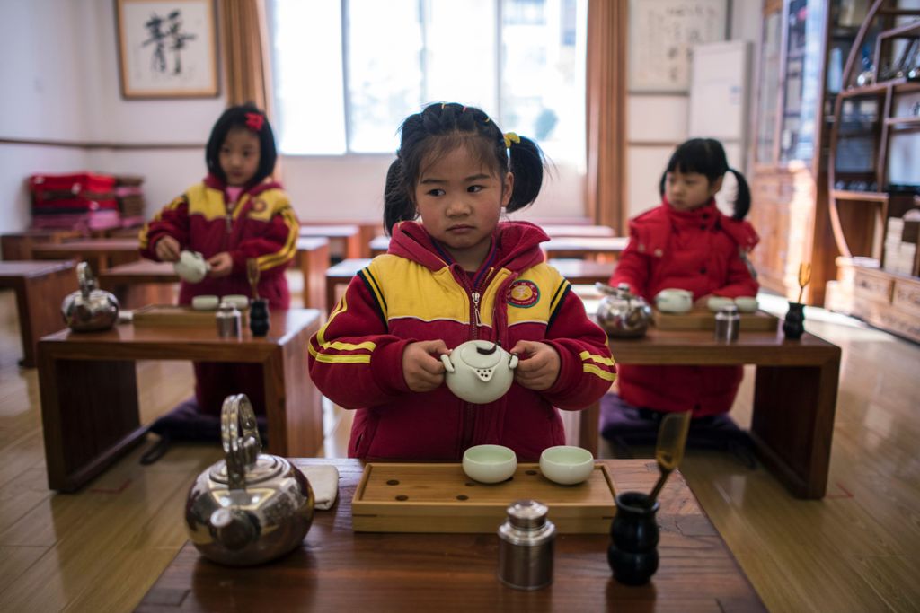 This picture taken on February 2, 2016 shows girls learning to perform a tea ceremony at a Confucius kindergarten in Wuhan. With central government backing, hundreds of private schools dedicated to Confucian teachings have sprung up across the country in 