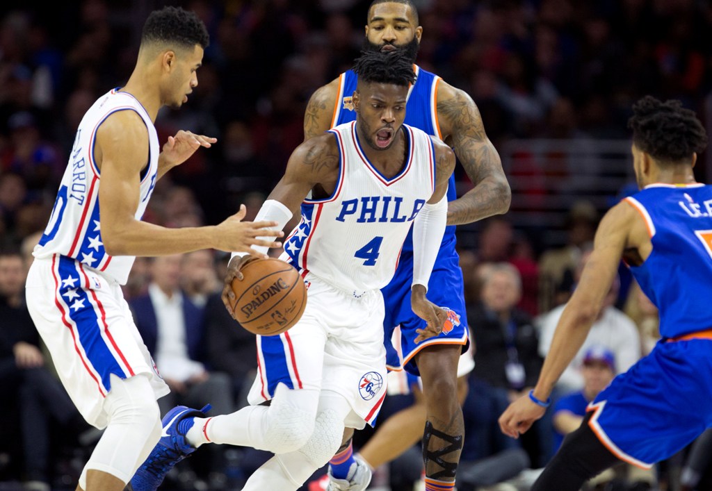 Philadelphia 76ers forward Nerlens Noel (4) dribbles past guard Timothe Luwawu-Cabarrot (20) and New York Knicks center Kyle O'Quinn (9) during the second half at Wells Fargo Center. Bill Streicher