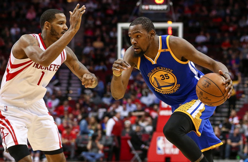 Golden State Warriors forward Kevin Durant (35) dribbles the ball as Houston Rockets forward Trevor Ariza (1) defends during the third quarter at Toyota Center. Troy Taormina
