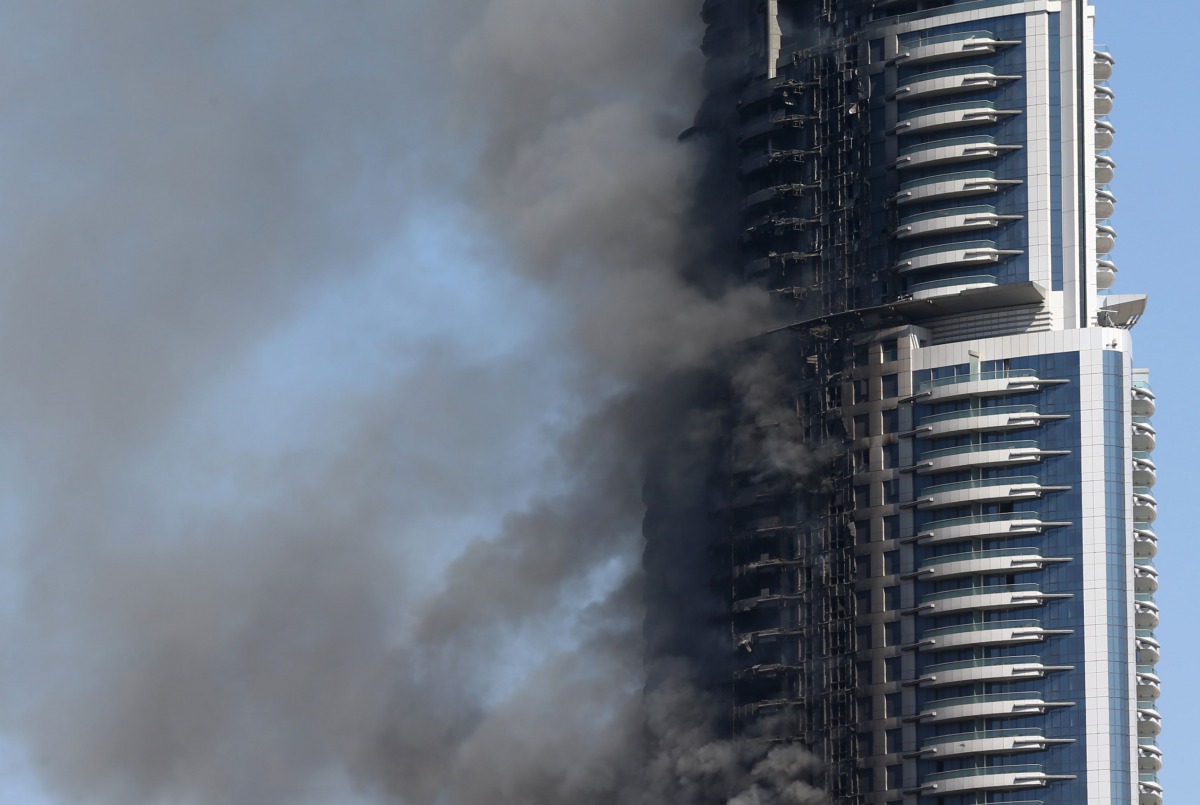 This file photo taken on January 01, 2016 shows smoke billowing from the Address Downtown Hotel in Dubai in the aftermath of a huge fire that engulfed several floors of the building. Dubai on January 22, 2017 announced tougher fire rules in a bid to minim