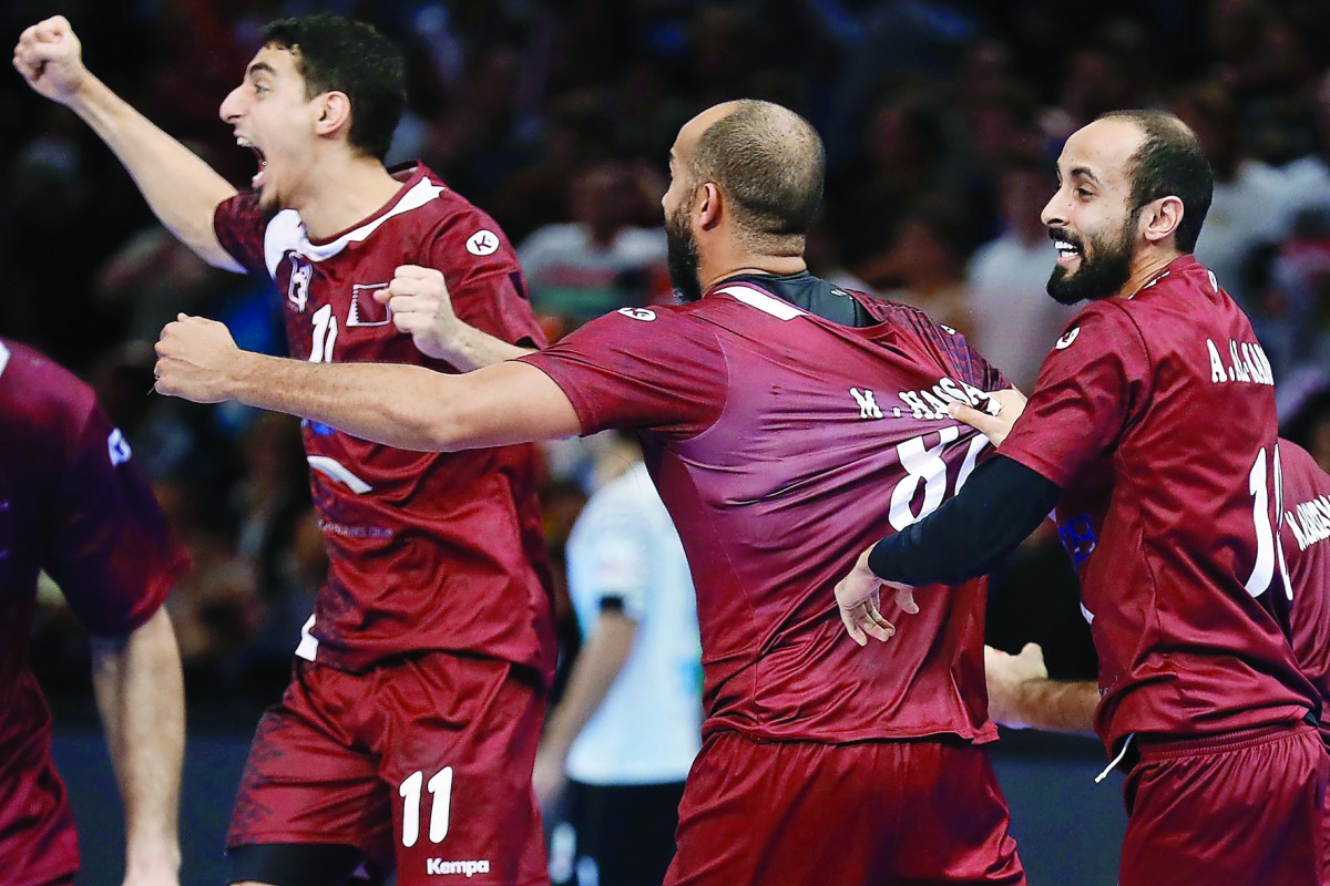 (From left) Qatar's left wing Murad Abdulrazzaq, centre back Mahmoud Hassaballa and right wing Abdullah Al Karbi celebrate after Al Anabi defeated Germany in the 25th IHF Men's World Championship 2017 Eighth Final against Germany at the AccorHotels Arena 