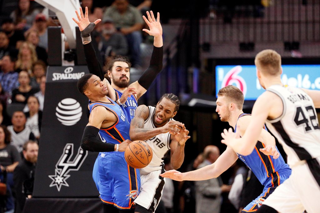 San Antonio Spurs small forward Kawhi Leonard (right) is fouled by Oklahoma City Thunder point guard Russell Westbrook (left) during the second half at AT&T Center. Soobum Im-USA TODAY Sports