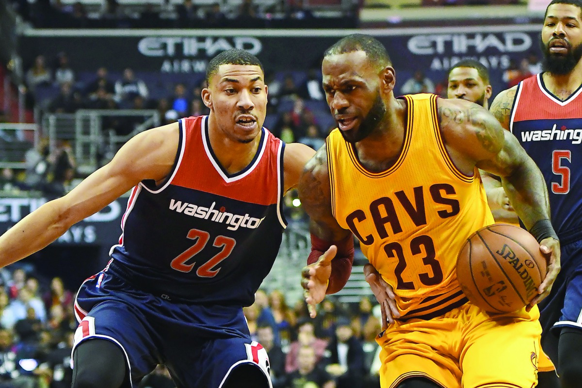 Cleveland Cavaliers forward LeBron James (right) drives to the basket against Washington Wizards forward Otto Porter Jr. during the first quarter of their NBA game at Verizon Center in Washington on Monday. 