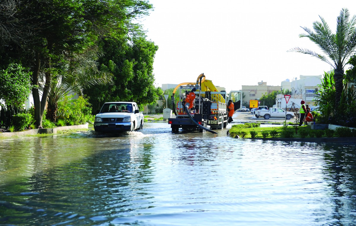 Workers removing water from two streets in Al Hilal area yesterday. Pic by: Salim Matramkot / The Peninsula