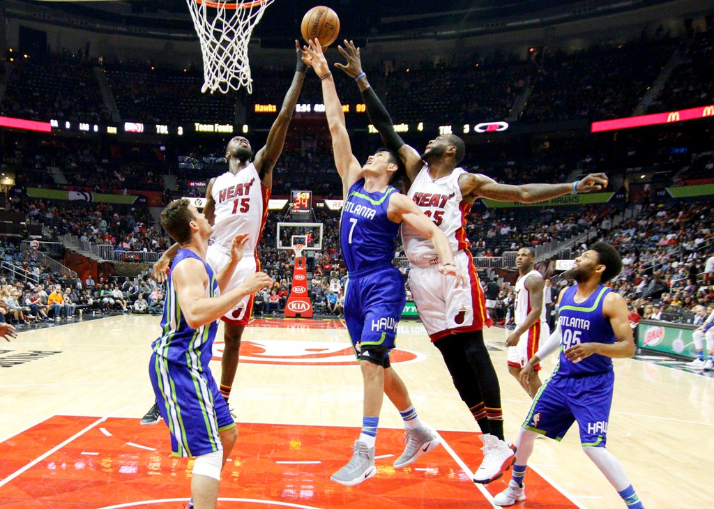 Atlanta Hawks forward Ersan Ilyasova (7) battles for a rebound against Miami Heat forward Okaro White (15) and forward Willie Reed (35) in the fourth quarter at Philips Arena. The Heat won 108-90. Brett Davis
