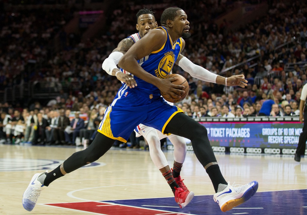 Golden State Warriors forward Kevin Durant (35) drives against Philadelphia 76ers forward Robert Covington (33) during the first quarter at Wells Fargo Center. Bill Streicher
