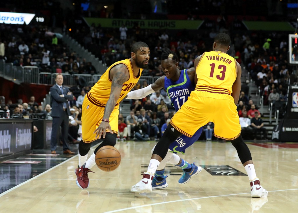 Cleveland Cavaliers guard Kyrie Irving (2) defended by Atlanta Hawks guard Dennis Schroder (17) as Cleveland Cavaliers center Tristan Thompson (13) sets a pick in the first quarter of they game at Philips Arena. Jason Getz