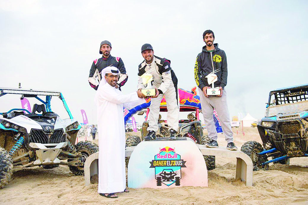 The winner of one of the events at the Qatar National Sprint receives his trophy from an official at Losail on Friday.  