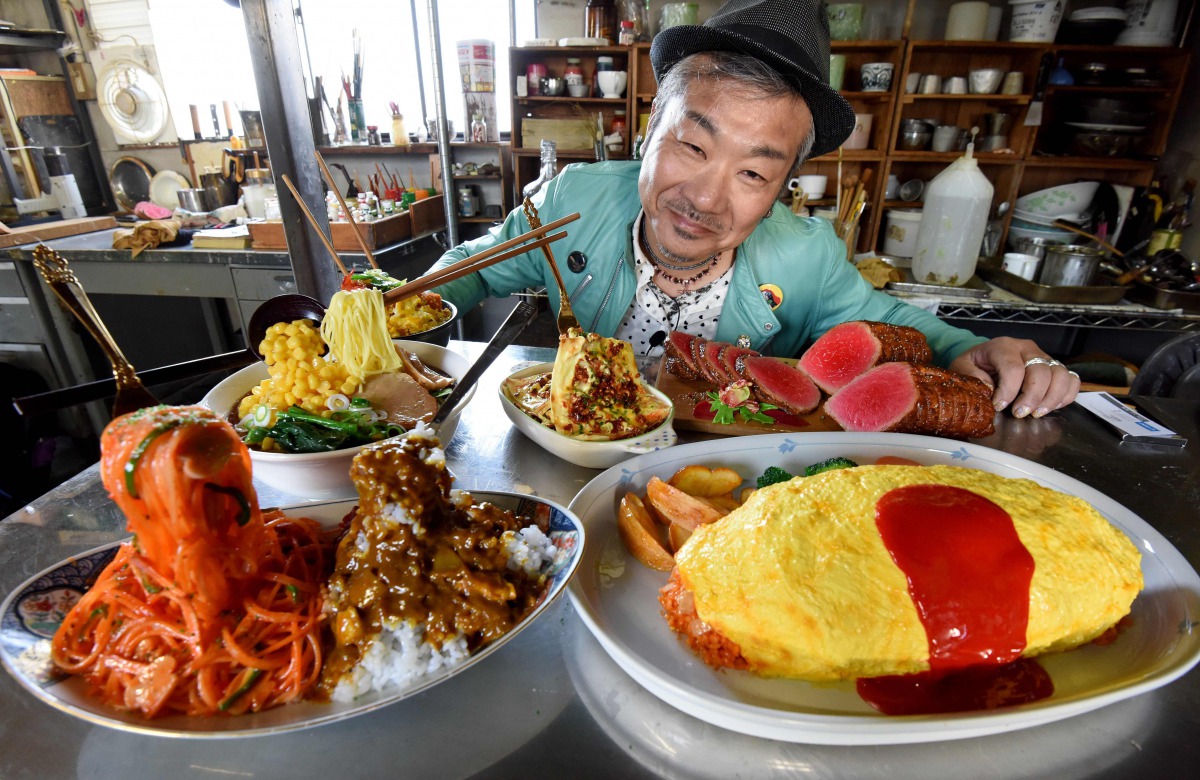 This picture taken on January 18, 2017 shows Norihito Hatanaka, president of Fake Food Hatanaka, introducing plastic food dishes at his company's studio in Tokorozawa, a suburb of Tokyo. They may look good enough to eat, but Japan's mouthwatering food rep