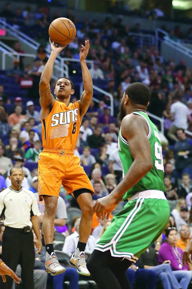 Tyler Ulis (left) of the Phoenix Suns attempts a shot against the Boston Celtics during their  NBA game at Talking Stick Resort Arena on Sunday. 