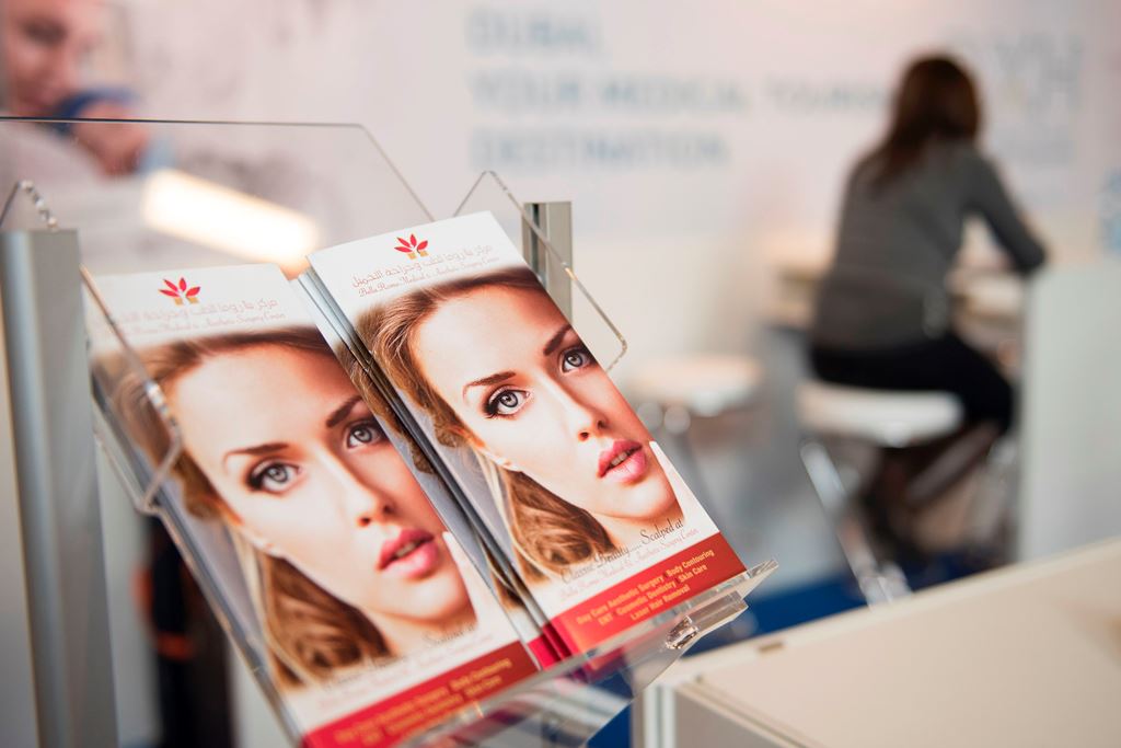 (FILES) This file photo taken on March 08, 2017 shows information material for plastic surgery displayed at a section for medical tourism at the International Tourism Trade Fair (ITB) on March 8, 2017. AFP / STEFFI LOOS 