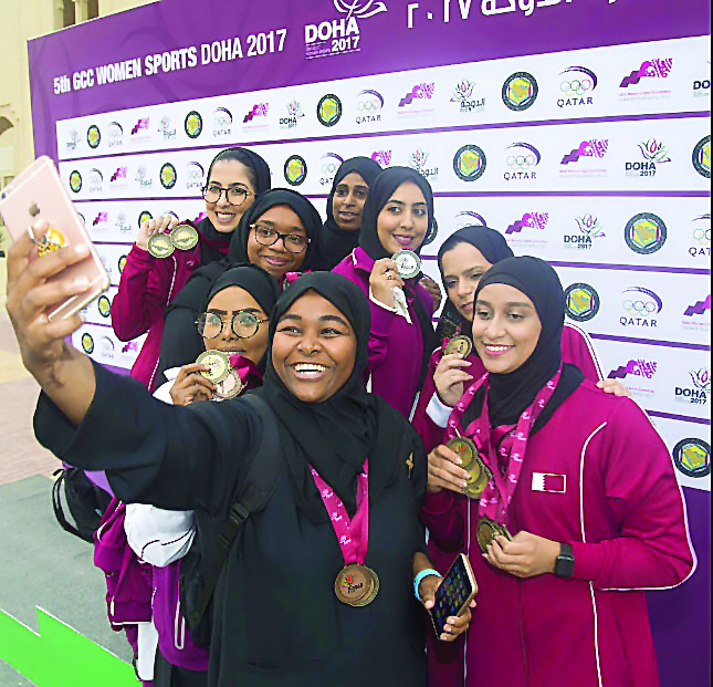 Qatari athletes display their medals as they pose for a group photo after the athletics competitions at the GCC Women's Games in Doha on Saturday.   