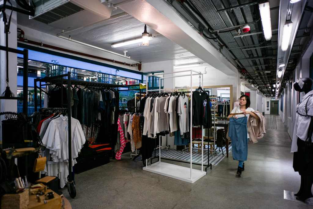 In this picture taken on March 17, 2017, a customer browses clothes in an independant fashion shop in Hong Kong. AFP / Anthony WALLACE 