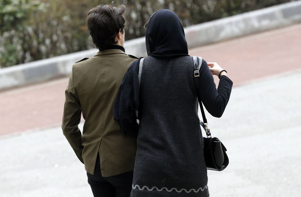 An Iranian couple walk in a park in the capital Tehran on March 14, 2017.  AFP / Atta Kenare