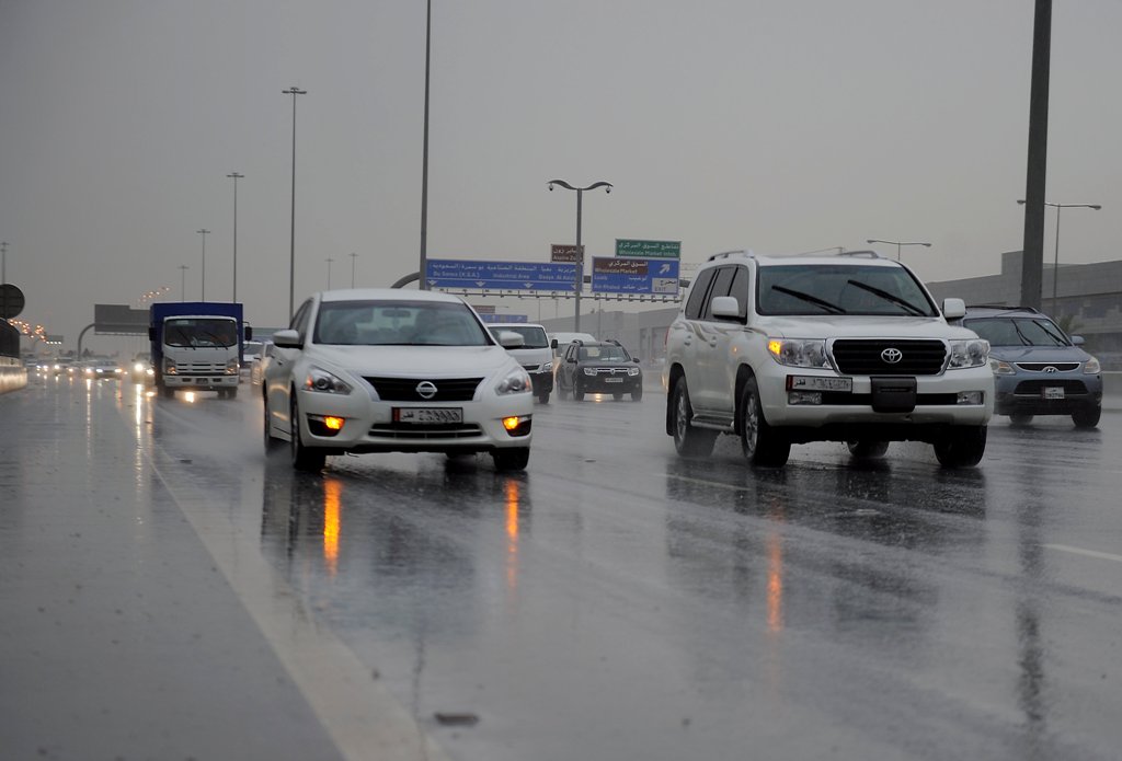 (File Photo) Cars moving early morning in heavy rain on Salwa road. March 16, 2016. Abdul Basit © The Peninsula