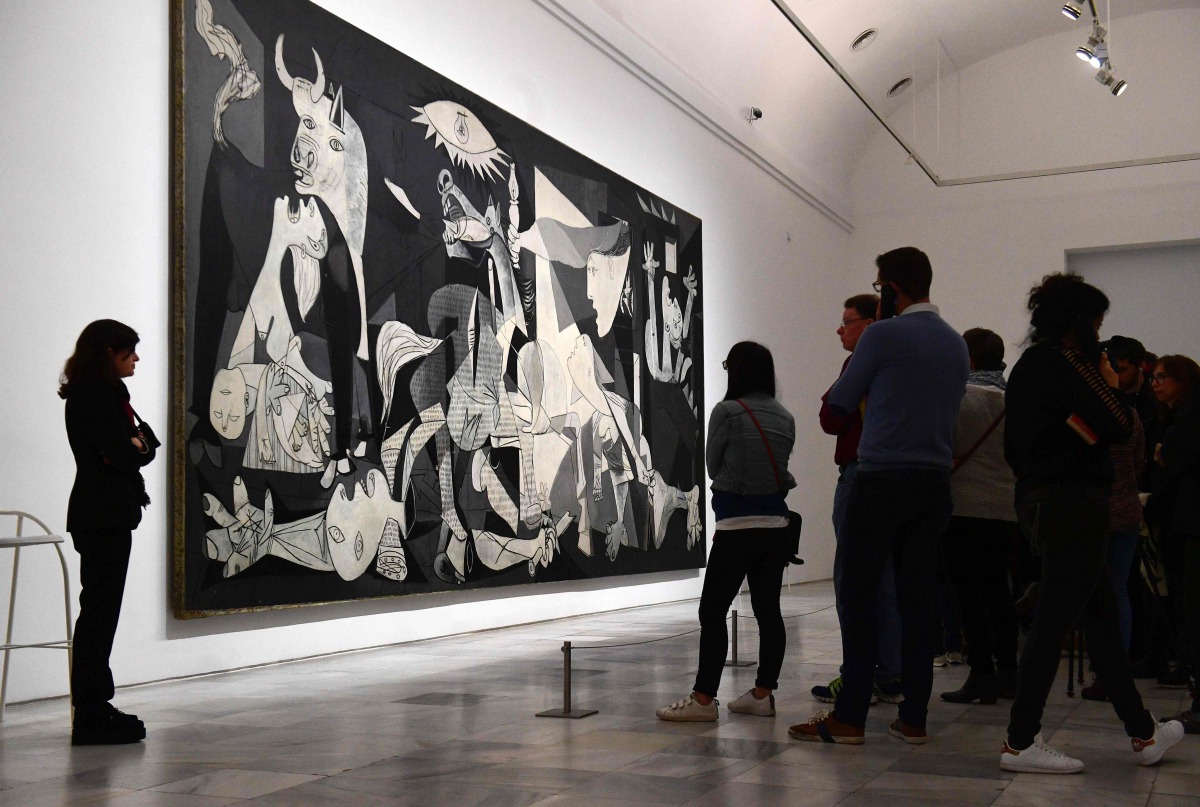 Visitors look at Spanish artist Pablo Picasso's painting, 