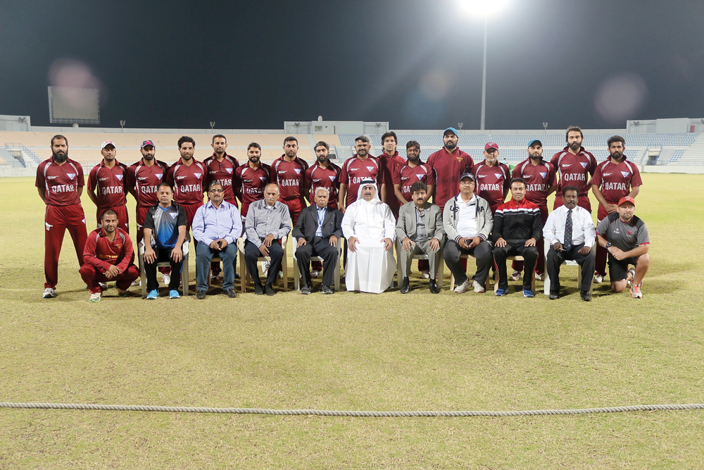 Qatar cricket team players and coaches pose for a photograph with officials of the Qatar Cricket Association.