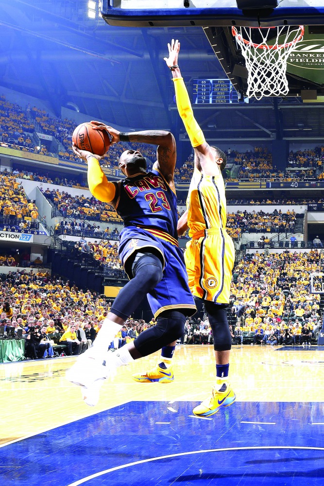 LeBron James (left) of the Cleveland Cavaliers goes to the basket against Paul George of the Indiana Pacers in the second quarter of Game Five of the NBA Eastern Conference First Round during the 2017 NHL Stanley Cup Playoffs at Bankers Life Fieldhouse in