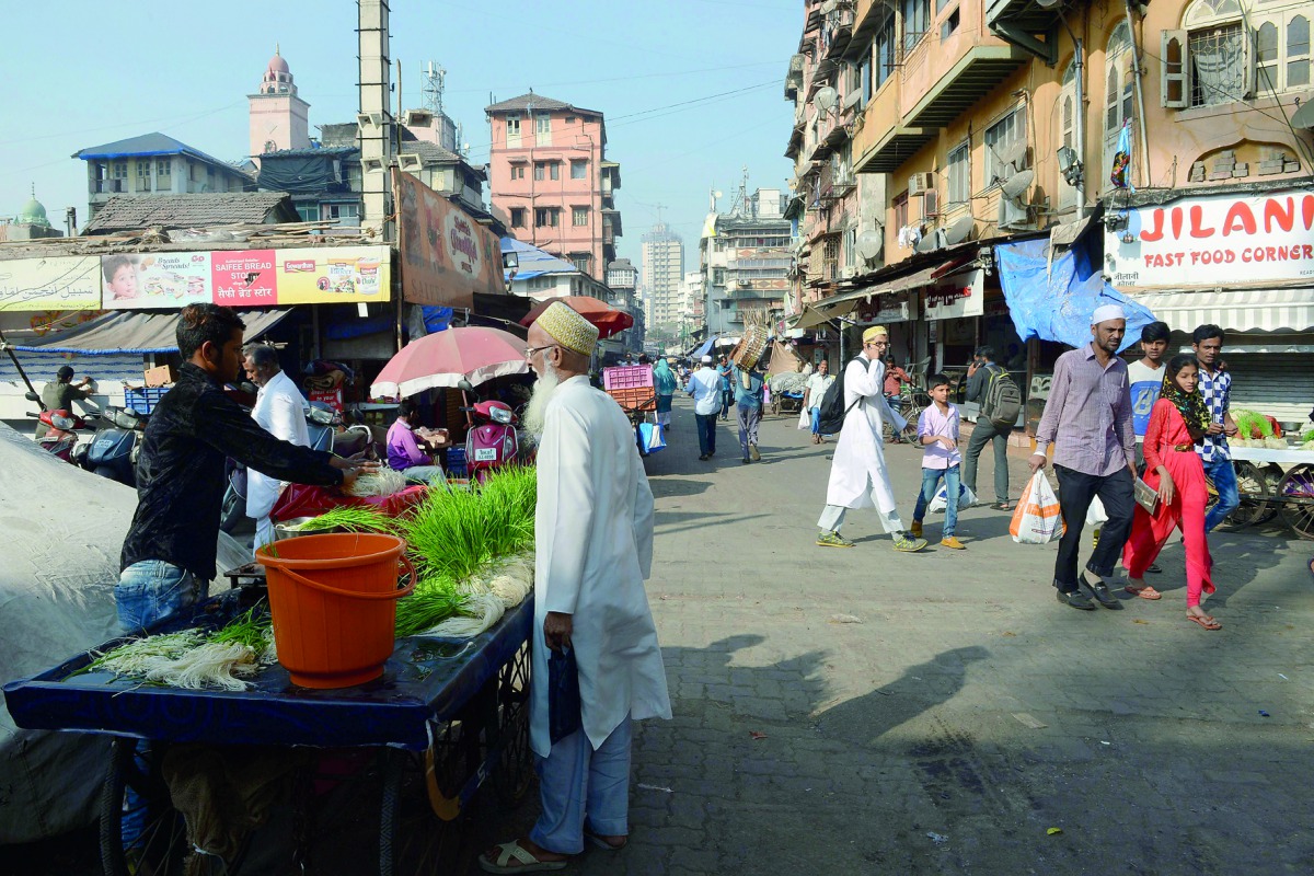 This photo taken on December 2, 2016 shows members of the Dawoodi Bohra community in the Bhendi Bazaar area of Mumbai, which is being redeveloped under the Cluster Development Act 2009 by the Saifee Burhani Upliftment Trust. AFP / Indranil Mukherjee