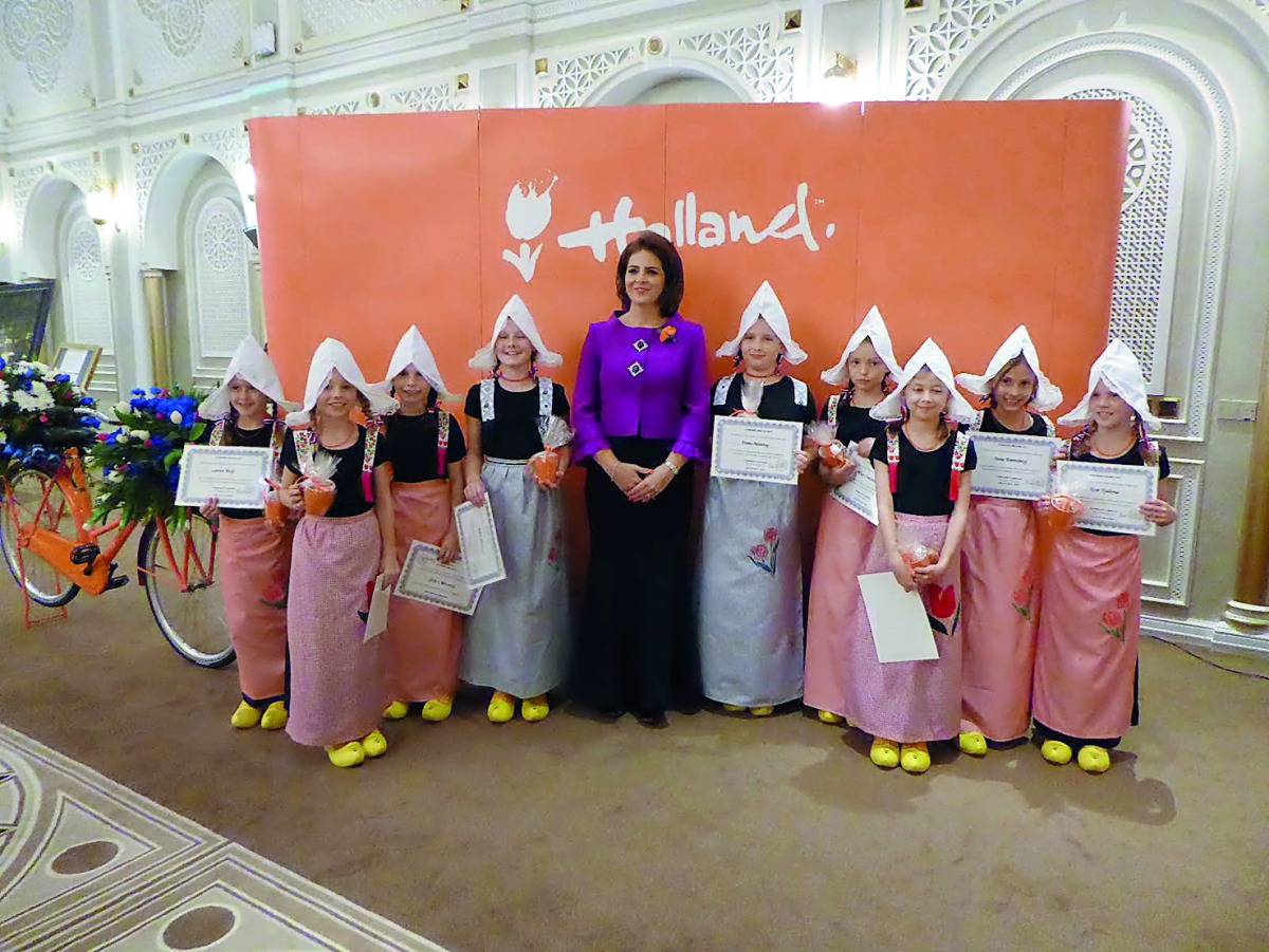 Ambassador of the Kingdom of the Netherlands to Qatar, Dr Bahia Tahzib-Lie, on King's Day with kids dressed in traditional Dutch outfits.