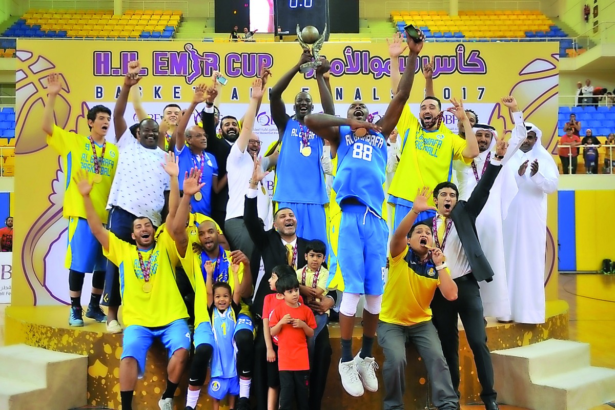 Champion Al Gharafa team players and officials celebrate with the Emir's Cup trophy at the Al Gharafa Indoor hall. Al Gharafa put up a splendid display to beat El Jaish 92-82 and secure their fourth Emir's Cup title. Picture: Baher Amin/The Peninsula