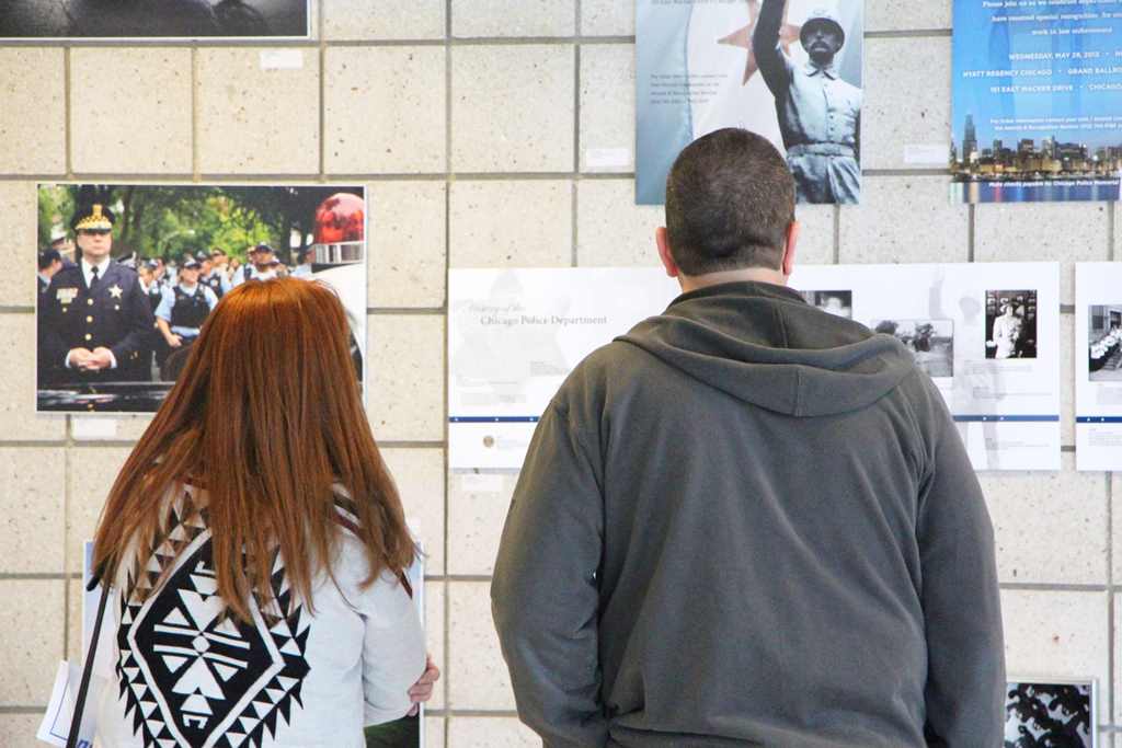 Visitors observe the works of police officers at a Chicago police station exhibition on May 5, 2017. Entitled 